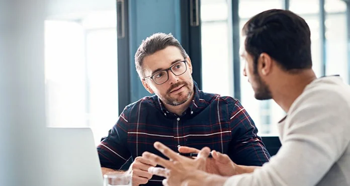 Two business people in a focused one-to-one conversation